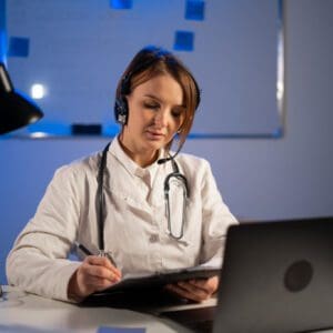 Medical professional with headset at desk